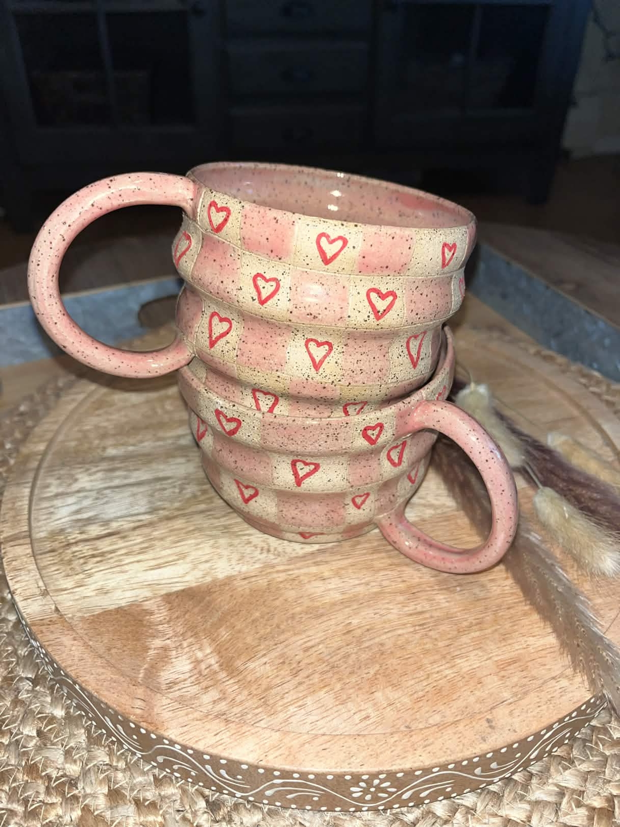 2 small mugs with checkered and heart designs