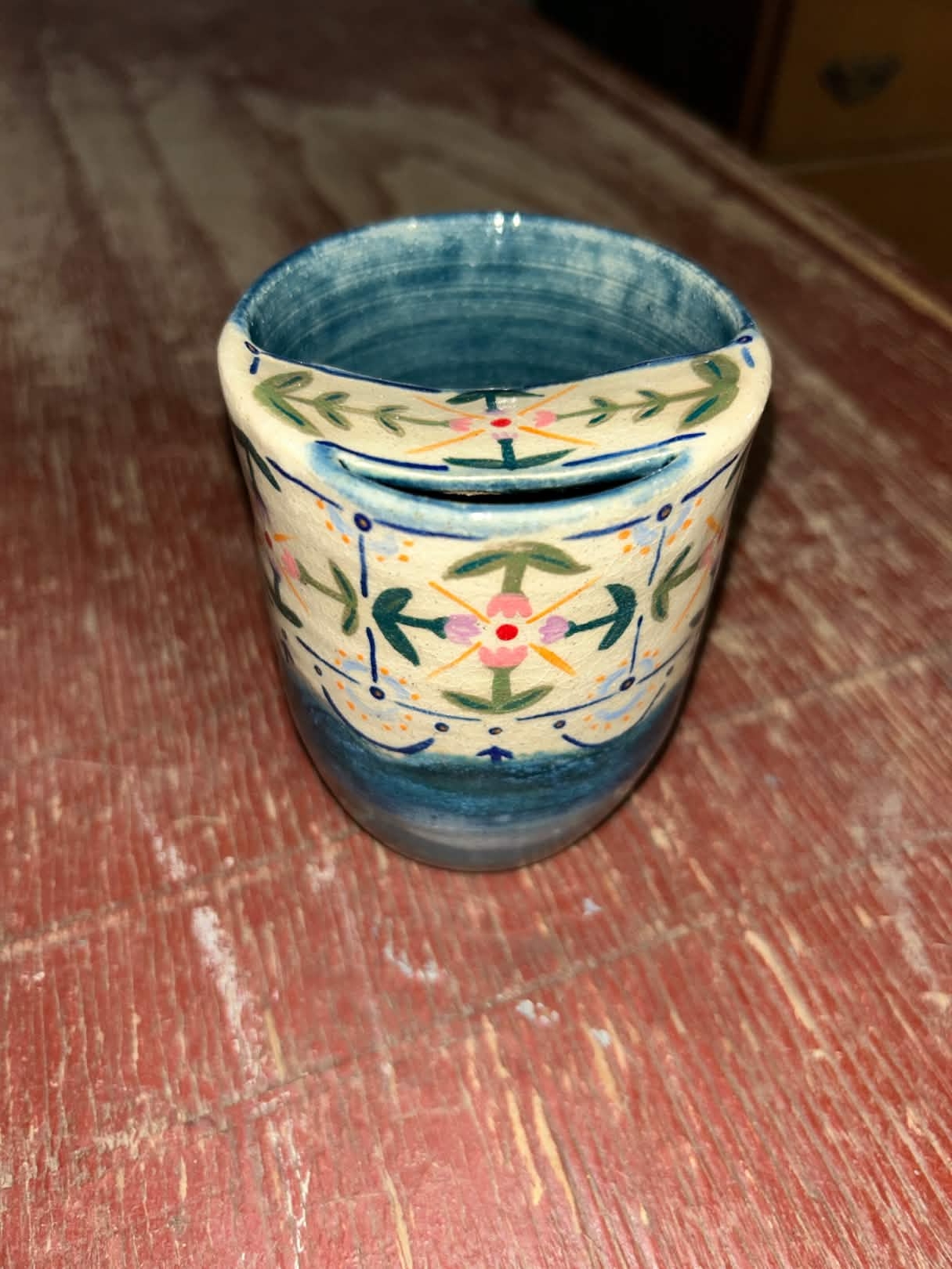 Blue tumbler with colorful designs